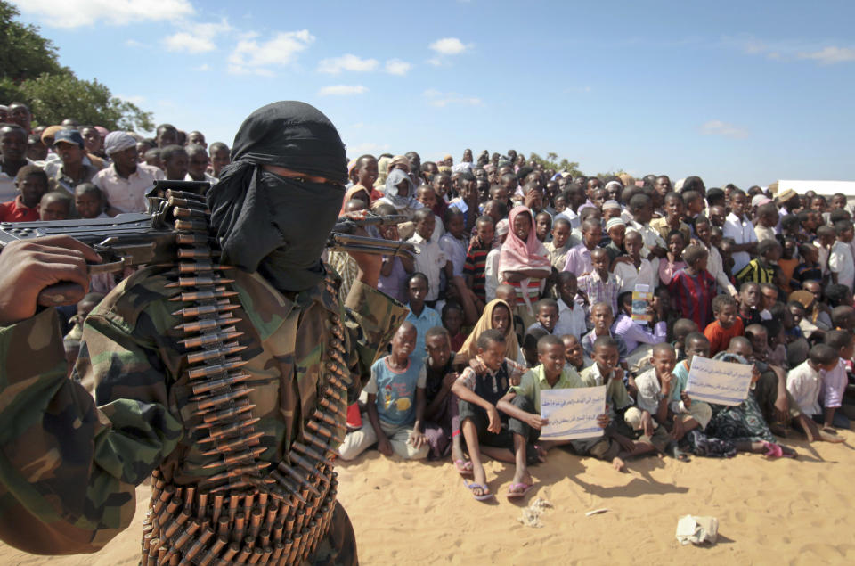 FILE - In this Monday, Feb. 13, 2012 file photo, an armed member of the militant group al-Shabab attends a rally on the outskirts of Mogadishu, in Somalia. Abu Mohamed, an al-Shabab commander, told The Associated Press Monday, Jan. 27, 2014 that Sahal Iskudhuq, who was killed in Sunday’s U.S. missile attack, had previously been in charge of kidnappings of foreigners and ransom deals for the group but recently turned to working with its intelligence unit. (AP Photo, File)