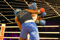 <p>Emmanuel Etienne (red gloves) clobbers David Thompson with a ring during a Heavyweight bout in the NYPD Boxing Championships at the Hulu Theater at Madison Square Garden on March 15, 2018. (Gordon Donovan/Yahoo News) </p>