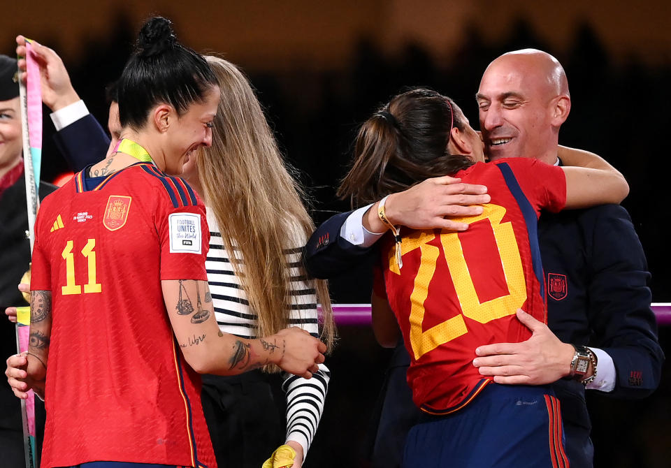 Spain # 20 defender Rosio Galvez is congratulated by Royal Spanish Football Federation President Luis Rubiales (R) next to Spain # 10 Jennifer Hermoso after winning the 2023 Australia/New Zealand Women's World Cup Final between Spain and England at Stadium Australia in Sydney, August 20, 2023 ( Photo by FRANCK FIFE/AFP) (Photo by FRANCK FIFE/AFP via Getty Images)