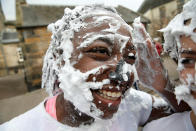 <p>Students from St Andrews University indulge in a tradition of covering themselves with foam to honor the “academic family” on Lower College Lawn on Oct. 23, 2017, in St Andrews, Scotland. (Photo: Jeff J Mitchell/Getty Images) </p>