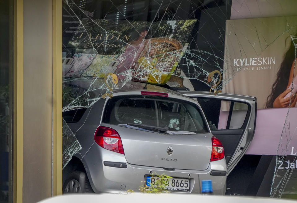 A car has crashed into a store after crashing into a crowd of people in central Berlin, Germany, Wednesday, June 8, 2022. (AP Photo/Michael Sohn)