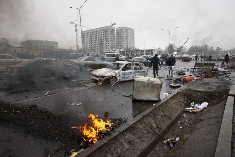 FILE - A car, which was burned after clashes, is seen on a street in Almaty, Kazakhstan, Friday, Jan. 7, 2022. The government, by then led by Nazarbayev's close ally Tokayev, responded with a deadly clampdown, culminating in a "shoot-to-kill" order as the president blamed "terrorists" allegedly funded and trained from abroad. (AP Photo/Vasily Krestyaninov, File)