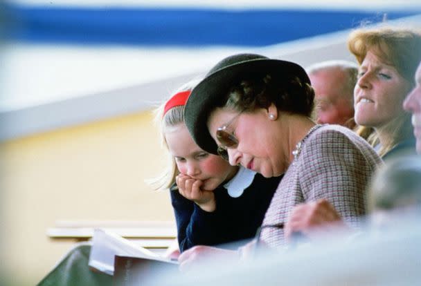 PHOTO: Queen Elizabeth II reading with her granddaugter Zara Phillips at Windsor Horse Show. (Tim Graham/Getty Images)