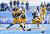 Kent State wide receiver Dante Cephas (14) turns away from Wyoming cornerback C.J. Coldon (21) after a reception during the first half of the Idaho Potato Bowl NCAA college football game, Tuesday, Dec. 21, 2021, in Boise, Idaho. (AP Photo/Steve Conner)