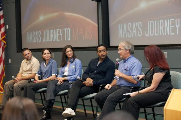 Participating in a discussion at Kennedy Space Center aimed at students were: Michael Johansen, NASA research engineer; Gioia Massa, NASA project scientist; Nicole Stott, a retired NASA astronaut; Chiwetel Ejiofor, an actor who portrays Vincent