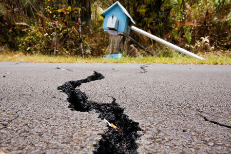 A crack is seen in a road in the Leilani Estates subdivision during ongoing eruptions of the Kilauea Volcano in Hawaii, U.S., May 13, 2018. REUTERS/Terray Sylvester