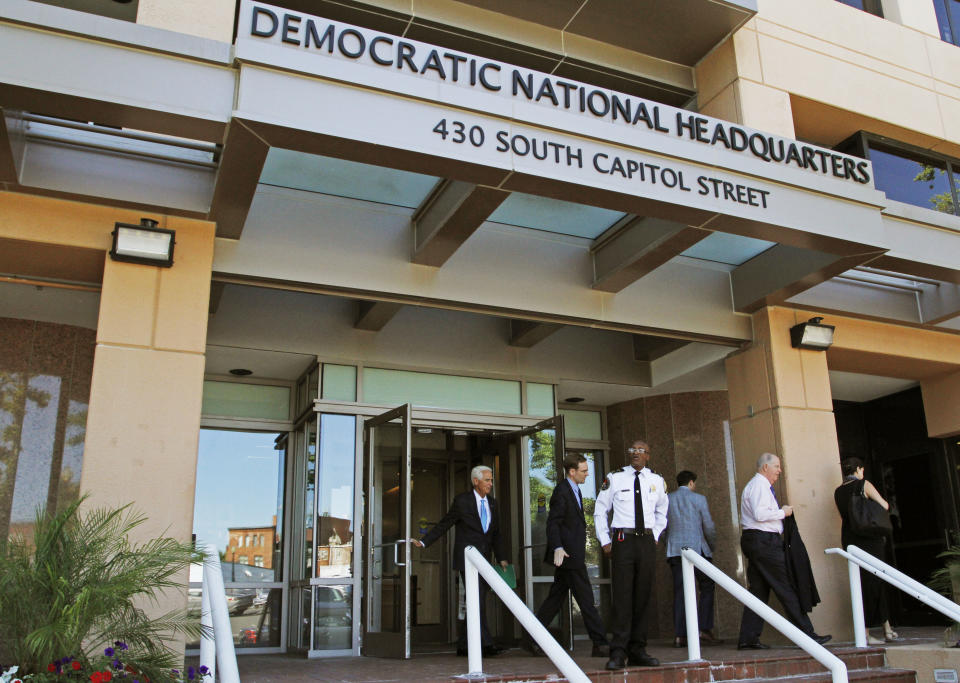 FILE - In this June 14, 2016 file photo, people stand outside the Democratic National Committee headquarters in Washington. Hackers tried to break into DNC inboxes in March 2016 and intensified their efforts in early April. (AP Photo/Paul Holston, File)