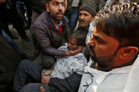 Supporters of Mohammad Yasin Malik, Chairman of Jammu Kashmir Liberation Front (JKLF), a separatist party, sit around him on a road as they try to take out a protest march in Srinagar December 17, 2018. REUTERS/Danish Ismail