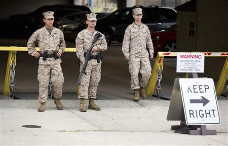 Members of the United States Marine Corps maintain a watch on their barracks as police respond to a shooting at the Washington Navy Yard, in Washington September 16, 2013. REUTERS/Joshua Roberts