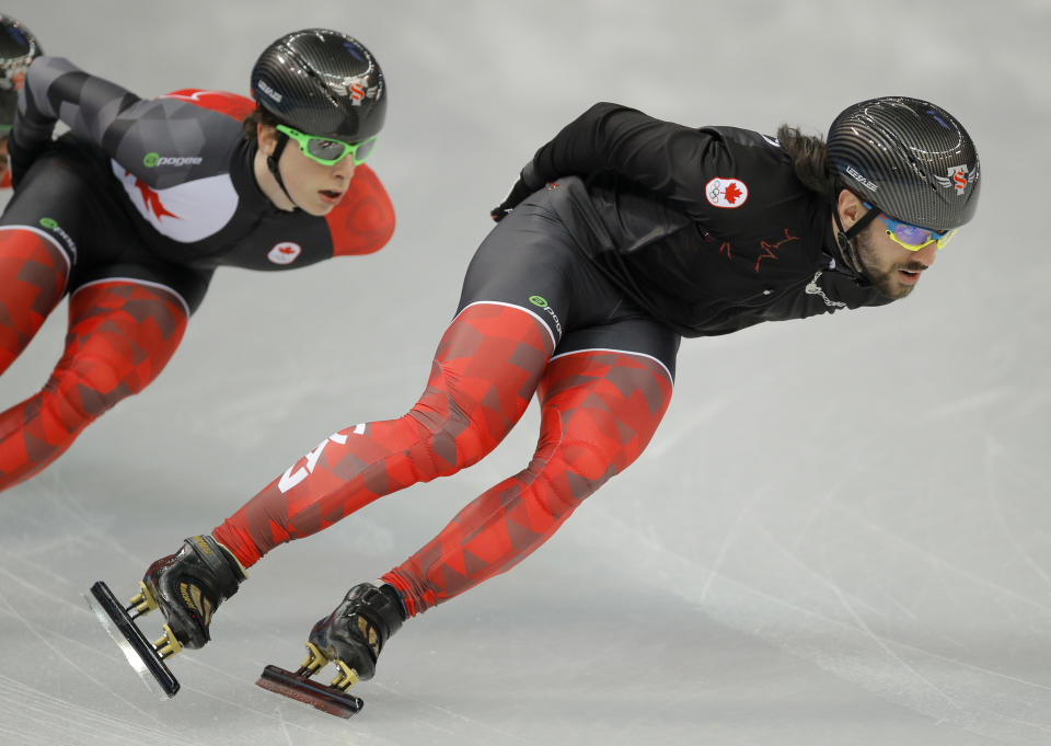 Charles Hamelin of Canada, right, trains during a short track speedskating practice session at the Iceberg Skating Palace ahead of the 2014 Winter Olympics, Thursday, Feb. 6, 2014, in Sochi, Russia. (AP Photo/Vadim Ghirda)