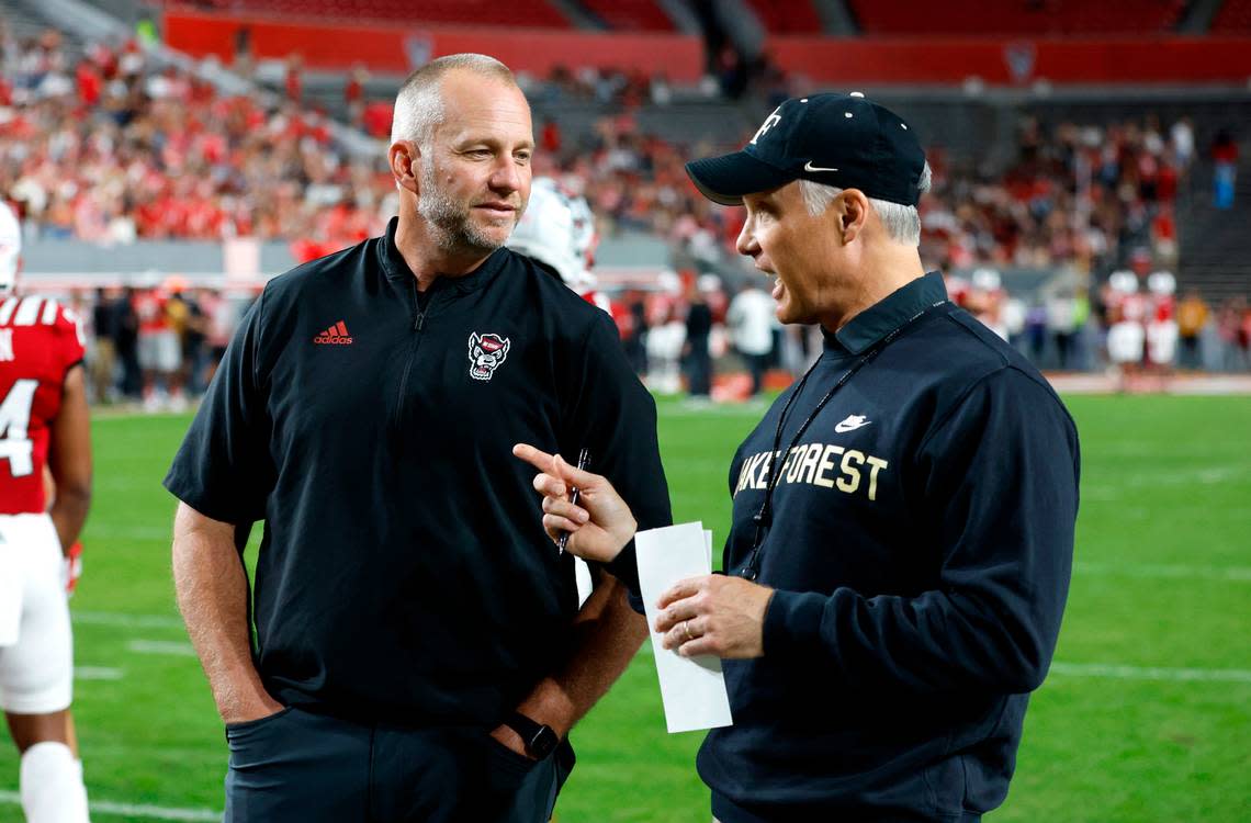 N.C. State head coach Dave Doeren talks with Wake Forest head coach Dave Clawson before N.C. State’s game against Wake Forest at Carter-Finley Stadium in Raleigh, N.C., Saturday, Nov. 5, 2022.