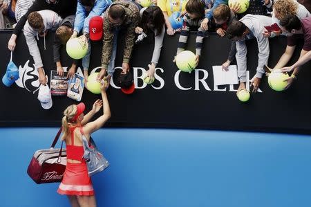 Maria Sharapova of Russia signs autographs after defeating Eugenie Bouchard of Canada in their women's singles quarter-final match at the Australian Open 2015 tennis tournament in Melbourne January 27, 2015. REUTERS/Brandon Malone