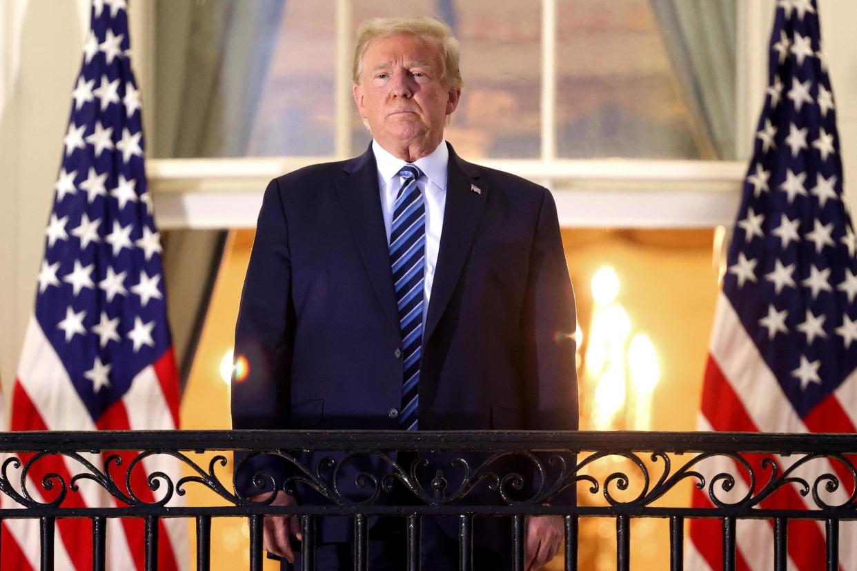 Donald Trump stands on the Truman Balcony after returning to the White House from hospital: Getty Images