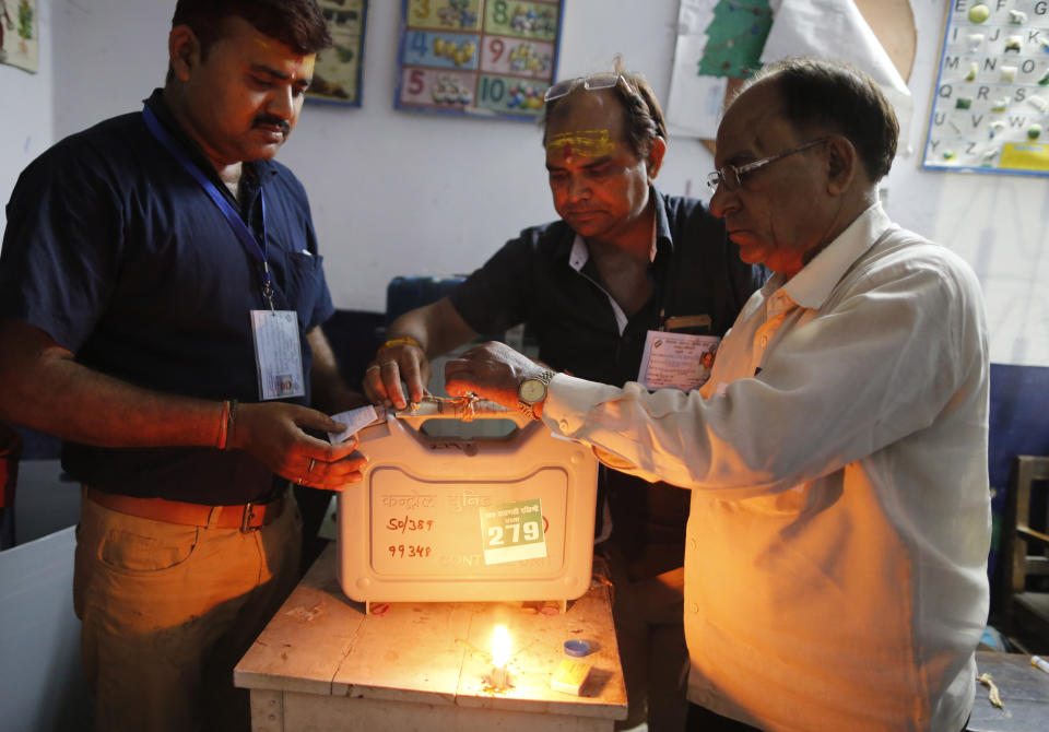 Election officers seal an electronic voting machine at the end of polling in Varanasi, India, Sunday, May 19, 2019. Indians voted in the seventh and final phase of national elections, wrapping up a 6-week-long long, grueling campaign season with Prime Minister Narendra Modi's Hindu nationalist party seeking reelection for another five years. Counting of votes is scheduled for May 23. (AP Photo/Rajesh Kumar Singh)