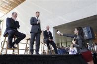 Don Garber (L), MLS commissioner and Miami-Dade County Mayor Carlos Gimenez look on as David Beckham (2nd L) discusses matters related to the ownership position he has with a proposed MLS expansion team that could play in Miami, at a news conference in Miami, Florida February, 5, 2014. REUTERS/Andrew Innerarity