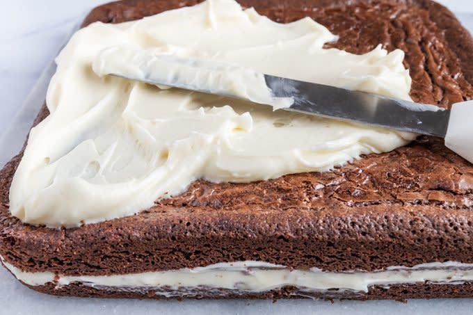 Layering the brownies and cream cheese filling for Olive Garden Chocolate Lasagna