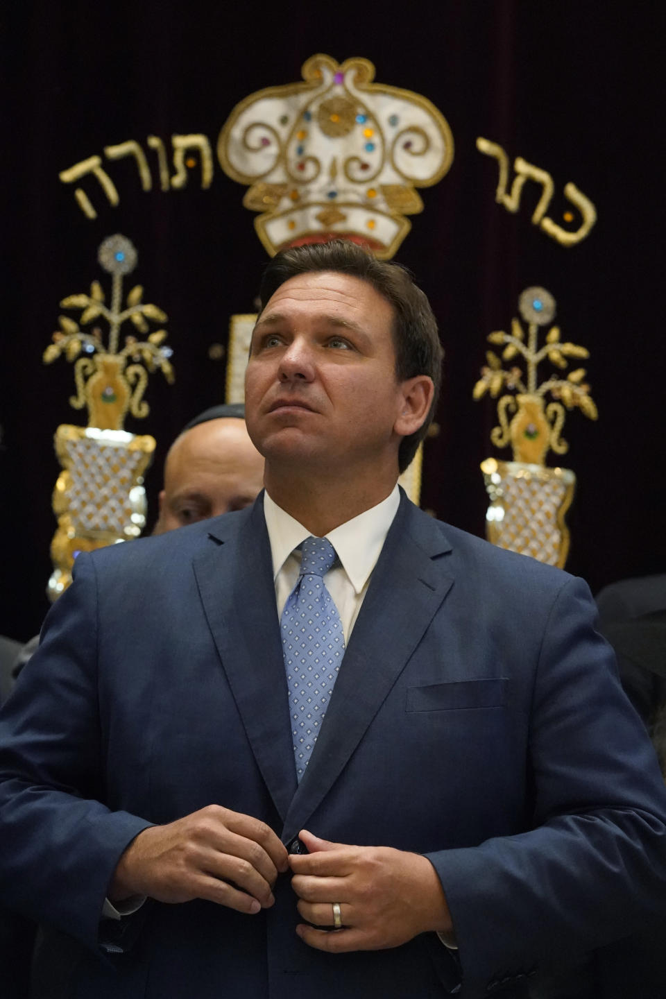 FILE - Florida Gov. Ron DeSantis buttons his jacket after speaking on June 14, 2021, at the Shul of Bal Harbour, a Jewish community center in Surfside, Fla. This swath of South Florida used to be a Democratic stronghold but has moved to the right, helping former President Donald Trump win the state in 2020 and DeSantis coast to a huge re-election win last year and flipping Miami-Dade County, long key to Democratic strength in the state. If Florida is to regain its status as a perennial battleground, how Jewish voters perceive Biden's handling of the Israel-Hamas war will be critical. (AP Photo/Wilfredo Lee, File)