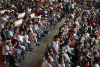 Spectators watch wrestling on the third and last day of the 660th instalment of the annual Historic Kirkpinar Oil Wrestling championship, in Edirne, northwestern Turkey, Sunday July 11, 2021.Thousands of Turkish wrestling fans flocked to the country's Greek border province to watch the championship of the sport that dates to the 14th century, after last year's contest was cancelled due to the coronavirus pandemic. The festival, one of the world's oldest wrestling events, was listed as an intangible cultural heritage event by UNESCO in 2010. (AP Photo/Emrah Gurel)