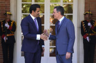 The Emir of Qatar Sheikh Tamim bin Hamad Al Thani, left, shakes hands with Spain's Prime Minister Pedro Sanchez at the Moncloa Palace in Madrid, Spain, Wednesday, May 18, 2022. The emir of Qatar said that his energy-rich gulf state is set to boost investments in Spain by 4.7 billion euros (4.9 billion) dollars in the coming years, Spanish media reported late on Tuesday. The details of the investments have not been made public but with Europe scrambling to find alternatives to Russian energy, Qatar is positioned to help fill the gap with exports of liquified natural gas. (AP Photo/Paul White)