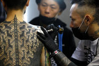 <p>A visitor to the London Tattoo Convention has a tattoo drawn on his body, in London, Britain, Sept. 23, 2017. (Photo: Peter Nicholls/Reuters) </p>