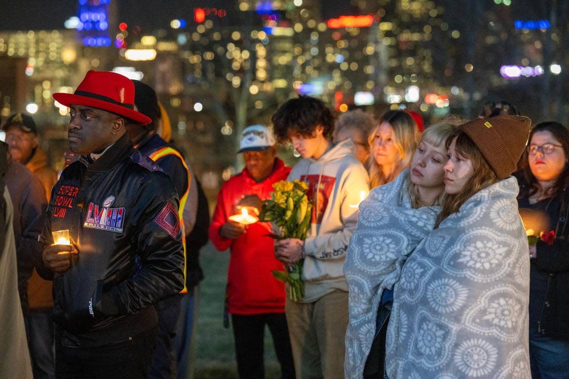Members of the community, including Jermaine Reed, left, a former City Council member, and Abbey Lewis, 22, second from right, and Jackie Batista-Martinez, 26, right, both of Kansas City, gathered at Skywalk Memorial Park in Kansas City for a candlelight vigil Thursday night to show support for the victims of the mass shooting, including Lisa Lopez-Galvan, who was killed in the shooting on Wednesday during the Chiefs Super Bowl rally.