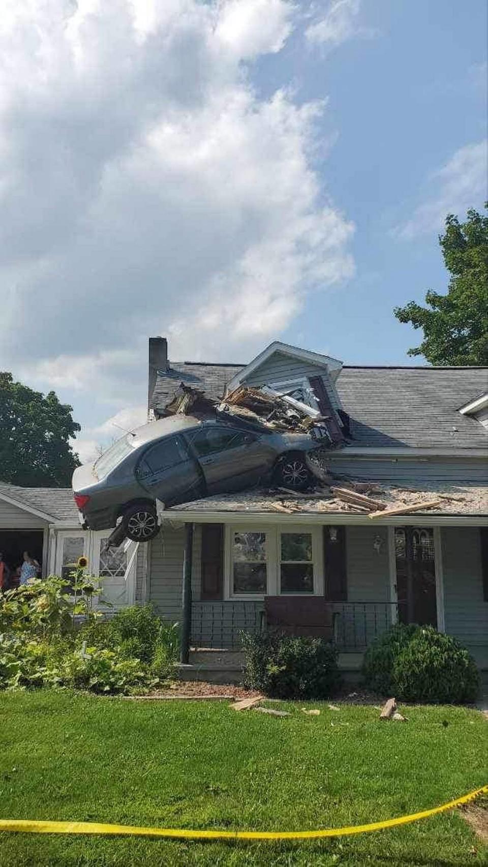 The rescuers removed the car and helped stabilize the home, officials said.