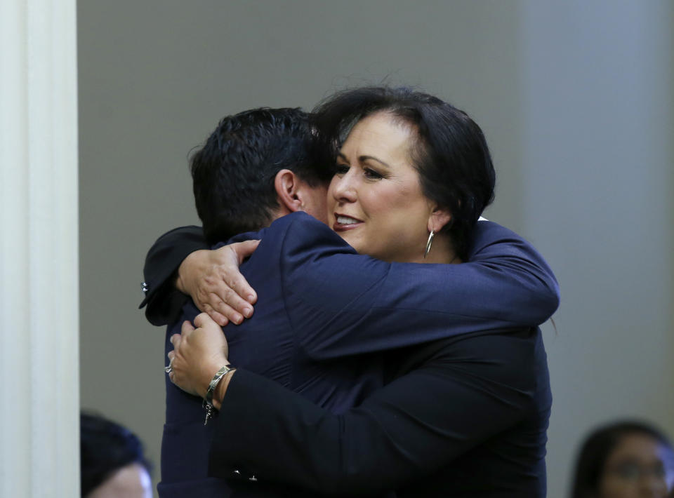 Assemblywoman Lorena Gonzalez, D-San Diego, receives congratulations from Assembly Speaker Anthony Rendon, of Lakewood after her to give new wage and benefit protections at the so-called gig economy companies like Uber and Lyft was approved by the Assembly in Sacramento, Calif., Wednesday, Sept. 11, 2019. The bill now goes to the governor, who has said he supports it. (AP Photo/Rich Pedroncelli)