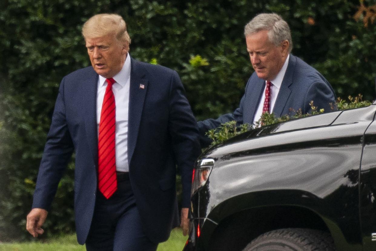 President Donald Trump talks to White House Chief of Staff Mark Meadows, right, as they walk from the Oval Office at the White House, Saturday, Sept. 12, 2020, in Washington. 