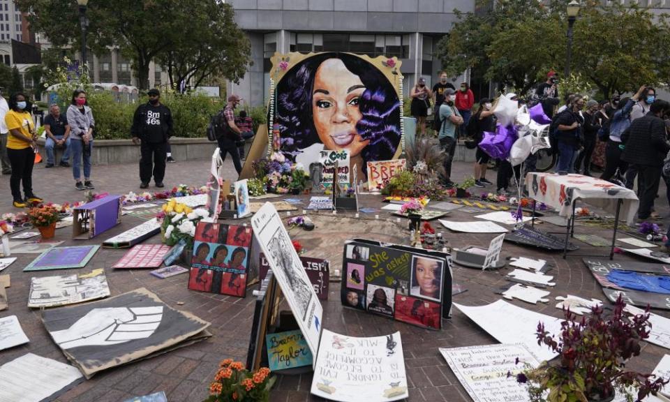 People gather in Jefferson Square where there is a memorial to Breonna Taylor.