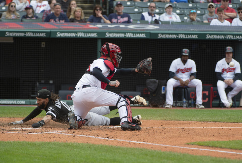 Chicago White Sox's Billy Hamilton, left, scores on a steal ahead of the tag of Cleveland Indians' Roberto Perez during the eighth inning of a baseball game in Cleveland, Sunday, Sept. 26, 2021. (AP Photo/Phil Long)