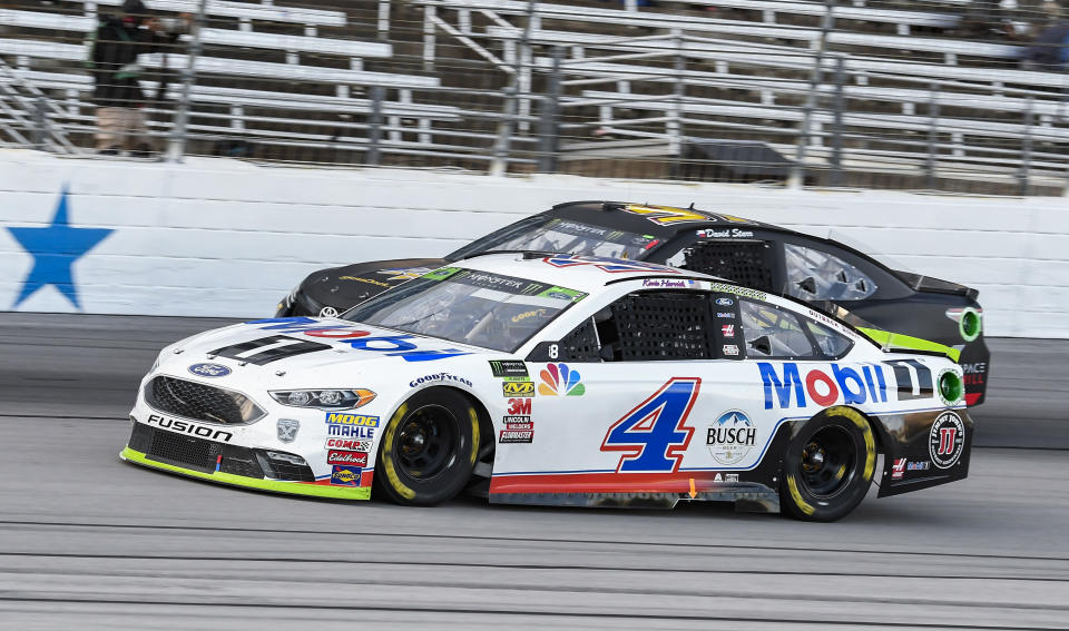 FILE - In this Sunday, Nov. 4, 2018, file photo, Kevin Harvick (4) passes David Starr (97) during the NASCAR Cup auto race at Texas Motor Speedway in Fort Worth, Texas. Harvick's bid for a second NASCAR title suffered a massive setback when he was stripped of his berth in the championship race after series inspectors found his winning car from Texas Motor Speedway had been deliberately altered to give him a performance advantage. (AP Photo/Larry Papke, File)