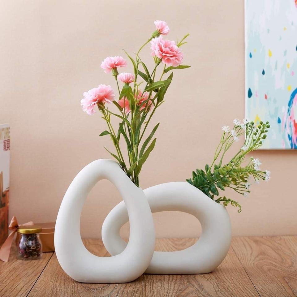 These eye-catching vases are sure to look good botanic-<i>all</i> over your apartment.<br /><br /><strong>Promising review:</strong> "We love these. They go so well with our modern/boho/Scandinavian home aesthetic. The texture is not smooth but like a chalkboard. I was surprised by that but it doesn't affect how much I love these vases." &mdash; <a href="https://www.amazon.com/gp/customer-reviews/R2L2356H7NH0MY?&amp;linkCode=ll2&amp;tag=huffpost-bfsyndication-20&amp;linkId=5660b07c0a3ba10b97e4cc6606fdbf9f&amp;language=en_US&amp;ref_=as_li_ss_tl" target="_blank" rel="nofollow noopener noreferrer" data-skimlinks-tracking="5854435" data-vars-affiliate="Amazon" data-vars-href="https://www.amazon.com/gp/customer-reviews/R2L2356H7NH0MY?tag=bfmal-20&amp;ascsubtag=5854435%2C18%2C37%2Cmobile_web%2C0%2C0%2C16331345" data-vars-keywords="cleaning,fast fashion" data-vars-link-id="16331345" data-vars-price="" data-vars-product-id="20945940" data-vars-product-img="" data-vars-product-title="" data-vars-retailers="Amazon">Andy Washington<br /><br /></a><strong>Get them from Amazon for <a href="https://www.amazon.com/Anding-White-Ceramic-Vase-LY432516SET/dp/B07NPQ4JTN?&amp;linkCode=ll1&amp;tag=huffpost-bfsyndication-20&amp;linkId=bf3009fe4598485a15502ca5e471b5d3&amp;language=en_US&amp;ref_=as_li_ss_tl" target="_blank" rel="nofollow noopener noreferrer" data-skimlinks-tracking="5854435" data-vars-affiliate="Amazon" data-vars-asin="B07NPQ4JTN" data-vars-href="https://www.amazon.com/dp/B07NPQ4JTN?tag=bfmal-20&amp;ascsubtag=5854435%2C18%2C37%2Cmobile_web%2C0%2C0%2C16325825" data-vars-keywords="cleaning,fast fashion" data-vars-link-id="16325825" data-vars-price="" data-vars-product-id="11998513" data-vars-product-img="https://m.media-amazon.com/images/I/311-PTU0JyL.jpg" data-vars-product-title="Anding White Ceramic Vase - Droplet Matte Surface Design - Modern Vase, Family, Wedding, Table Vase, Perfect Home Decor Vase (LY432516SET)" data-vars-retailers="Amazon">$29.99+</a> (available in two styles).</strong>