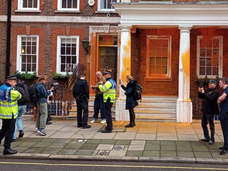 Two activists sprayed orange paint over the front of 55 Tufton Street in Westminster (Just Stop Oil)