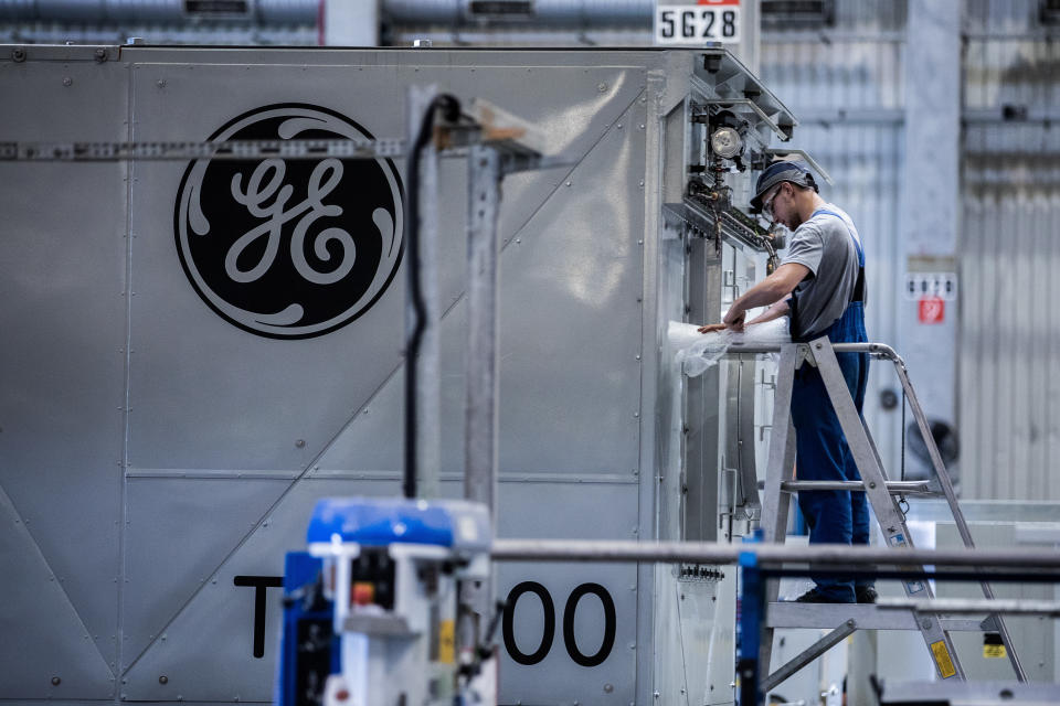 An employee unwraps turbine components inside the General Electric Co. power plant in Veresegyhaz, Hungary, on Tuesday, June 13, 2017. General Electric won approval on Monday from the U.S. Justice Department to combine its oil and gas business with Baker Hughes Inc. Photographer: Akos Stiller/Bloomberg via Getty Images