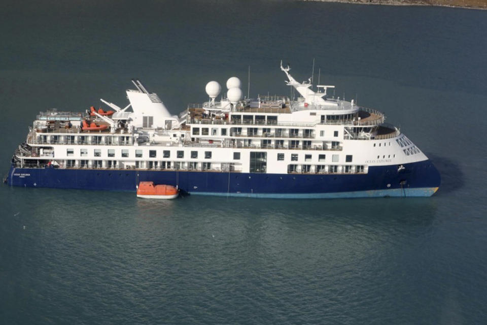 An aerial photo shows the Ocean Explorer, a Bahamas-flagged Norwegian cruise ship with 206 passengers and crew, which has run aground in northwestern Greenland, on Tuesday, Sept. 12, 2023. The 104.4-meter (343-foot) long and 18-meter (60 foot) wide Ocean Explorer ran aground on Monday in Alpefjord in the Northeast Greenland National Park. It's the world’s largest and most northerly national park and is known for icebergs and the musk oxen that roam the coast. According to authorities no one on board was in danger and no damage has been reported. (Danish Air Force/Joint Arctic Command via AP)