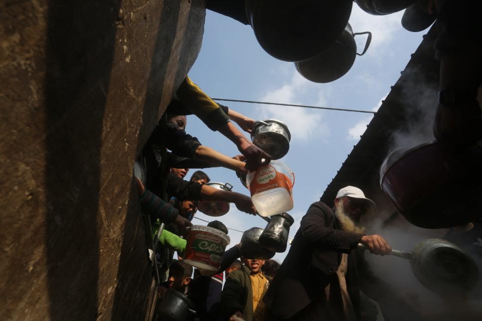 Palestinians line up for free food during the ongoing Israeli air and ground offensive on the Gaza Strip in Rafah, Tuesday, Jan. 9, 2024. ((AP Photo/Hatem Ali))