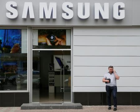 A man speaks on his mobile phone near a Samsung store in central Kiev, Ukraine, May 11, 2016. REUTERS/Valentyn Ogirenko