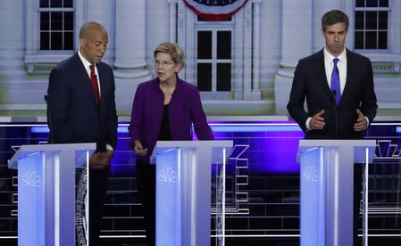 U.S. Senator Booker talks with Senator Warren before the start of the first U.S. 2020 presidential election Democratic candidates debate in Miami, Florida, U.S.,