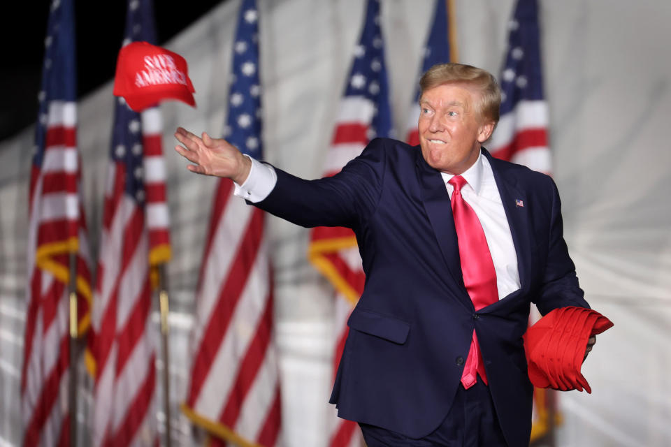 WAUKESHA, WISCONSIN - AUGUST 05: Former President Donald Trump tosses hats to supporters during a rally on August 05, 2022 in Waukesha, Wisconsin. Former President Trump endorsed Republican candidate Tim Michels in the governor's race against candidate Rebecca Kleefisch, who is supported by former Vice President Mike Pence.  (Photo by Scott Olson/Getty Images)