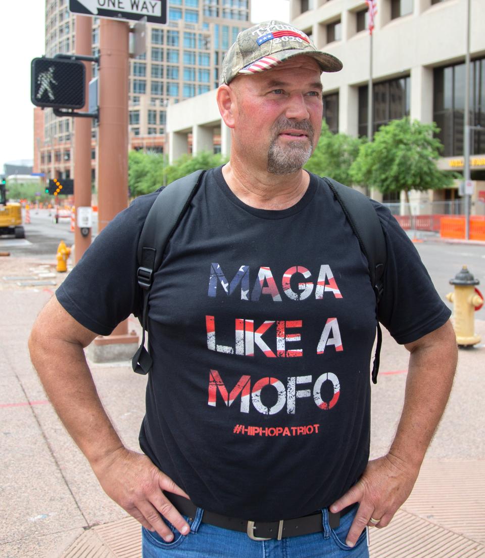 A man wears a shirt that says "MAGA LIKE A MOFO #HIPHOPATRIOT" in support of Former President Donald Trump who spoke at the Arizona Federal Theatre in Phoenix on July 24, 2021. It was Trump's first post-presidency visit to Arizona