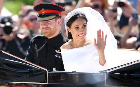 Prince Harry, Duke of Sussex and Meghan, Duchess of Sussex leave Windsor Castle in the Ascot Landau carriage during a procession after getting married at St Georges Chapel on May 19, 2018 in Windsor, England - Credit: Karwai Tang /WireImage