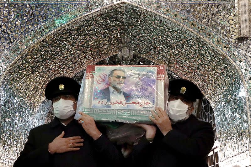 Servants of the holy shrine of Imam Reza carry the coffin of Iranian nuclear scientist Mohsen Fakhrizadeh, in Mashhad