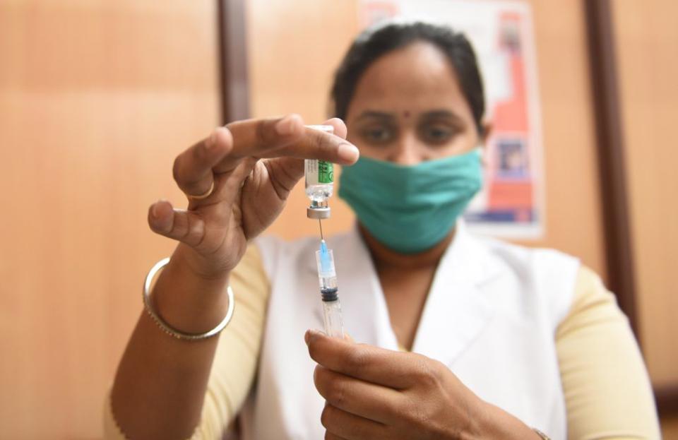 A health worker prepares a dose of Covishield vaccine on the first day of 'Tika Utsav' or Vaccination Festival, at a New Delhi Municipal Council dispensary on Babar Road near Bengali Market, in New Delhi, India. 