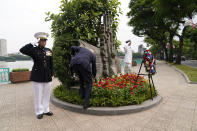 U.S. President Joe Biden places a presidential challenge coin at John Sidney McCain III Memorial in Hanoi, Vietnam, Monday, Sept. 11, 2023. (AP Photo/Evan Vucci)