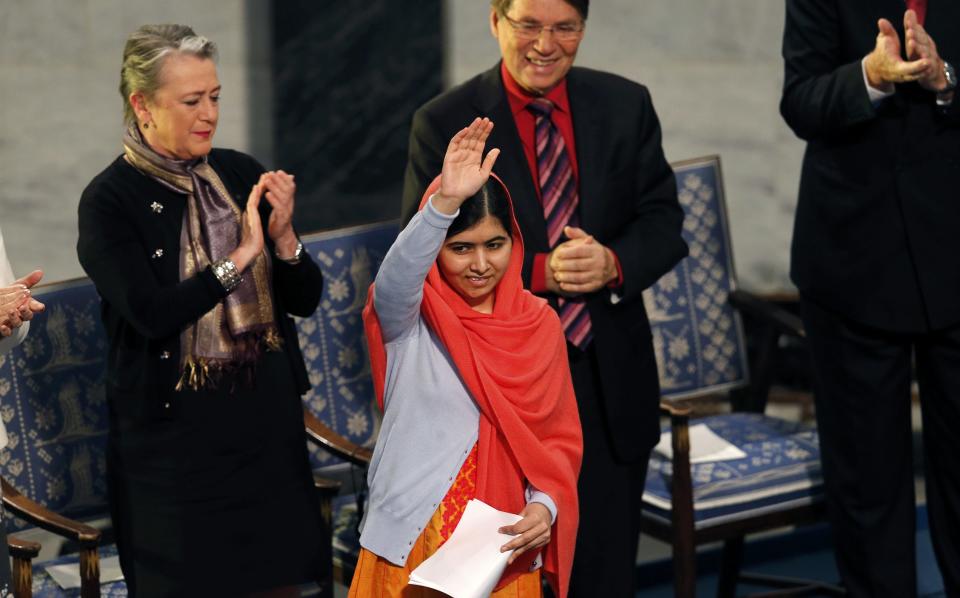 Nobel Peace Prize laureate Yousafzai waves after delivering her speech during the Nobel Peace Prize awards ceremony at the City Hall in Oslo