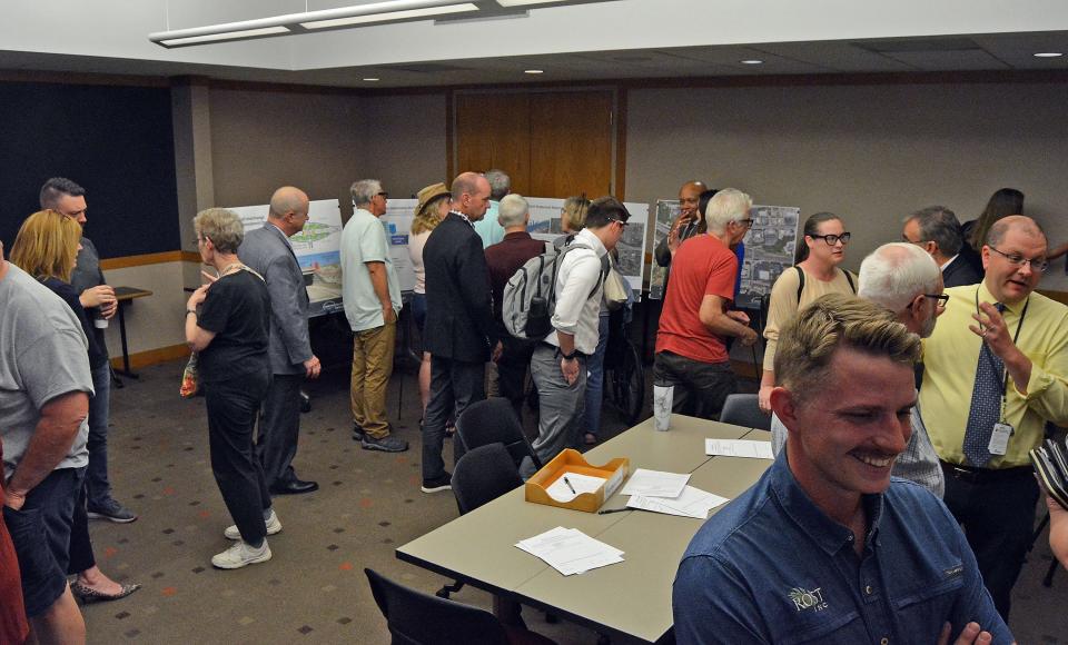 Community members review proposed design enhancements for the I-70/U.S. 63 connector project. The Missouri Department of Transportation usually uses utilitarian concrete, but works with communities to incorporate enhancements that are paid for by the communities, such as Columbia.