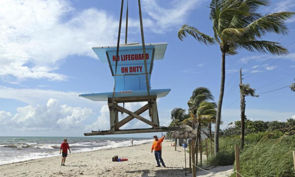 A lifeguard tower is removed in preparation for Hurricane Dorian as the storm approaches the Florida coast on Saturday.