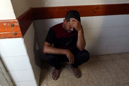 A relative of a Palestinian Hamas member, who was killed in an Israeli air strike, reacts at a hospital in the southern Gaza Strip July 19, 2018. REUTERS/Ibraheem Abu Mustafa