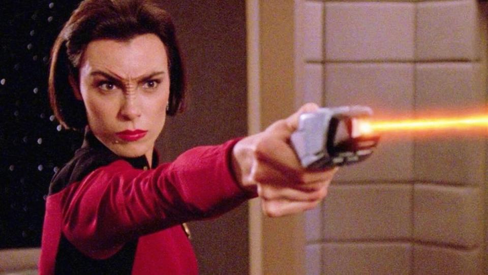 Ro Laren (Michelle Forbes) fires a phaser on the Enterprise bridge on Star Trek: TNG.