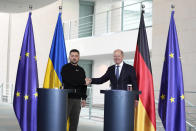 Germany's Chancellor Olaf Scholz, rigth, and Ukraine's President Volodymyr Zelenskyy address a media conference at the chancellery in Berlin, Germany, Sunday, May 14, 2023. Ukrainian President Volodymyr Zelenskyy arrived in Berlin early Sunday for talks with German leaders about further arms deliveries to help his country fend off the Russian invasion and rebuild what's been destroyed by more than a year of devastating conflict. (AP Photo/Matthias Schrader)